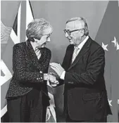  ?? EMMANUEL DUNAND/GETTY-AFP ?? EU’s President Jean-Claude Juncker greets Britain’s Theresa May, who must now sell a Brexit deal to Parliament.