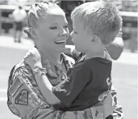  ?? ASSOCIATED PRESS ?? United States National Guard Tech. Sgt. Andrea Carrothers surprises her son William earlier this month in Minneapoli­s after she returned from a six-month deployment to Qatar.