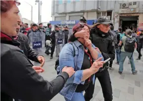  ?? - Reuters ?? DETAINED: A police officer detains a protester as she and others attempt to defy a ban and to gather at Taksim Square to celebrate May Day, in central Istanbul, Turkey on May 1, 2017.