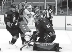  ?? RICK SCUTERI/AP ?? Coyotes goaltender Darcy Kuemper (35) makes a save against Minnesota Wild left wing Kevin Fiala, center, as Coyotes left wing Johan Larsson, left, defends in the first period Saturday in Glendale.