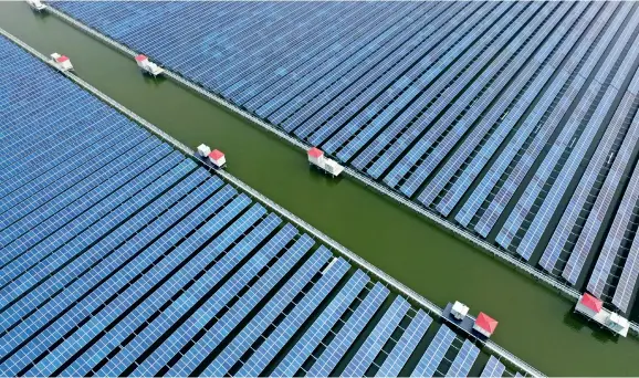  ??  ?? An aerial view of a fishery-solar hybrid system project in Ningbo City, Zhejiang Province, on January 10, 2017.