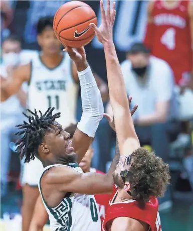  ?? DETROIT FREE PRESS ?? Michigan State forward Aaron Henry (0) is blocked by Indiana forward Race Thompson (25) in the first half against Indiana on Tuesday in East Lansing.