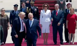  ?? — AP ?? US President Donald Trump with his Israeli counterpar­t Reuven Rivlin as First Lady Melania Trump, PM Benjamin Netanyahu and his wife Sara Netanyahu walk during a ceremony in Tel Aviv on Monday.