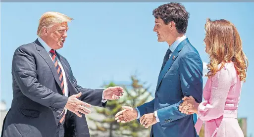  ?? GEOFF ROBINS/AFP/GETTY IMAGES ?? U.S. President Donald Trump is greeted by Prime Minister Justin Trudeau and his wife Sophie Grégoire Trudeau on the first day of the G7 summit in La Malbaie, Que.