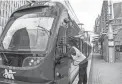  ?? ALBERTO MARIANI/THE REPUBLIC ?? Rod Evans, a valley metro line controller, talks with a train conductor at a light rail stop in downtown Phoenix on July 21.