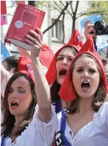  ??  ?? Red heads: Modern-day protesters in France wearing Phrygian caps
