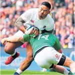  ??  ?? Andrew Conway tackles England’s Manu Tuilagi.