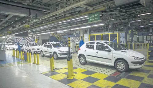  ?? AFP ?? In this photo taken on February 20, 2016 Peugeot 206 cars are seen on the final production line at Iran Khodro plant, west of Tehran.