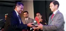  ??  ?? Commercial Bank’s Chief Manager eBanking Pradeep Banduwansa receiving the SLIPS award from Central Bank Governor Ajith Nivard Cabraal