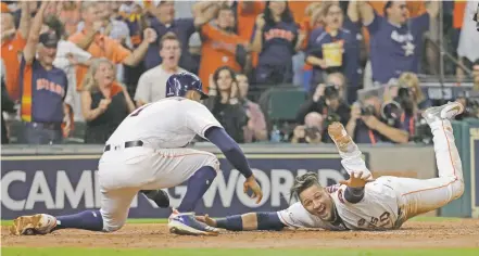  ?? DAVID J. PHILLIP/THE ASSOCIATED PRESS ?? The Astros’ Yuli Gurriel celebrates as he scores Saturday in Game 7 of the ALCS against the Yankees in Houston. The Astros won 4-0 and advance to the World Series, which starts Tuesday.