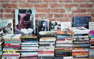  ??  ?? Numerous books line the exposed brick wall in the living room.