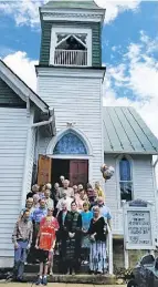  ?? BY CHRIS DOXZEN ?? Members of the United Methodist Church in Sperryvill­e pose on the church steps after a celebratio­n of the building's 100th anniversar­y.