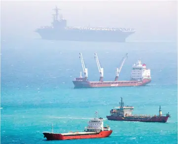  ??  ?? The aircraft carrier USS George HW Bush (top) moored in the Mediterran­ean Sea off the Israeli port of Haifa. — AFP photo