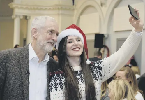  ??  ?? 0 Jeremy Corbyn poses for a selfie at a Christmas lunch in Edinburgh attended by people who have experience­d poverty