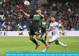  ??  ?? REGGIO EMILIA: Sassuolo’s forward Domenico Berardi (L) chest controls the ball under pressure from AC Milan’s Spanish forward Suso during the Italian Serie A football match Sassuolo vs AC Milan on Sunday at the Mapei stadium in Reggio Emilia. — AFP