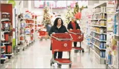  ?? Associated Press ?? Shoppers in November browse aisles at a Target store in Edison, N.J. When Macy’s and Kohl’s reported lackluster holiday sales on Thursday, investors were taken aback, sending retail stocks down.