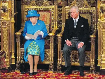  ?? — GETTY IMAGES ?? Queen Elizabeth II sits alongside her son Prince Charles as she delivers the Queen’s Speech in Parliament in London on Wednesday.