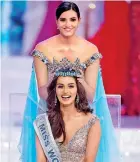  ??  ?? Miss World 2016 Stephanie Del Valle, from Puerto Rico (top) puts the crown on Miss India Manushi Chhilar (bottom) during the crowning ceremony in China