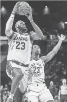  ?? ?? Lakers forward LeBron Jmaes goes to the basket against Pacers forward Aaron Nesmith on Saturday.