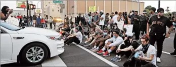  ?? DARRON CUMMINGS/AP ?? Protesters in Louisville, Kentucky, sit at an intersecti­on during a protest Saturday over the deaths of Breonna Taylor and George Floyd. Taylor was fatally shot in a March raid.