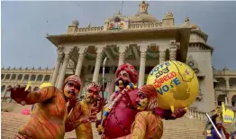  ?? — PTI ?? Artistes during the filming of a song for the upcoming Karnataka Assembly elections in front of Vidhanasou­dha in Bengaluru on Friday.