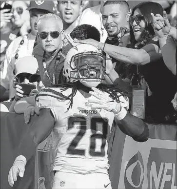  ?? D. Ross Cameron Associated Press ?? THE CHARGERS’ Melvin Gordon celebrates in front of Raiders fans after scoring a touchdown in October in Oakland. The Chargers expect to be in hostile territory again today, even for a home game at Stubhub Center.