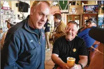  ?? AP FILE ?? Montana
U.S. House candidate and former Secretary of Interior Ryan Zinke (left) speaks with patrons at Metals Sports Bar and Grill, May 13 in Butte, Mont. Zinke is seeking election to a newly created U.S. House district.