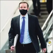  ?? Susan Walsh / Associated Press ?? Sen. Chris Murphy, D-Conn., walks on Capitol Hill in Washington on Friday, after the fourth day of the second impeachmen­t trial of former President Donald Trump.