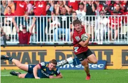  ?? GETTY IMAGES ?? George Bridge scores for the Crusaders as home fans celebrate in the background.