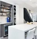  ??  ?? This Vancouver condo, the work of EuroCraft House, features a sleek kitchen with innovative storage.