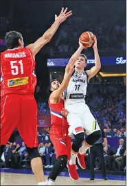  ?? Associated Press ?? Taking aim: In this Sept. 17, 2017, file photo, Slovenia's Luka Doncic, right, jumps to score a basket as Serbia's Vasilje Micic tries to stop him during their Eurobasket European Basketball Championsh­ip final match in Istanbul.