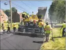  ?? Jeff Mill / Hearst Connecticu­t Media ?? Road crews were out paving Cromwell streets Wednesday afternoon.