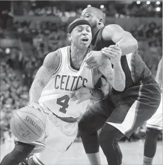  ?? Steven Senne Associated Press ?? ISAIAH THOMAS of the Boston Celtics drives past Raymond Felton of the Clippers in the first half. Thomas scored 28 points to lead the Celtics to their seventh consecutiv­e victory.