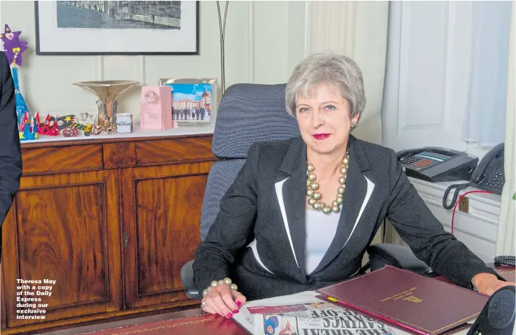  ?? Pictures: TIM CLARKE ?? Theresa May with a copy of the Daily Express during our exclusive interview