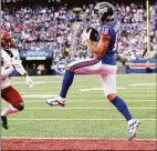  ?? Al Bello / Getty Images ?? The New York Giants’ Isaiah Hodgins catches a touchdown in the third quarter against the Washington Commanders at MetLife Stadium on Sunday in East Rutherford, N.J.