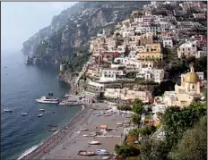  ?? Rick Steves’ Europe ?? Specializi­ng in scenery and sand, Positano scrambles down a cliff halfway between Sorrento and Amalfi.
