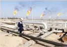  ?? — Reuters ?? A worker walks at Nahr Bin Umar oil field, north of Basra, Iraq.
