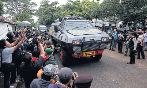  ?? REUTERS ?? An armoured police vehicle believed to be carrying condemned Australian prisoners Myuran Sukumaran and Andrew Chan arrives at the port yesterday to take a ferry to the prison island of Nusa Kambangan, where upcoming executions are expected to take place.