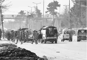  ??  ?? Army vehicles and ambulances gather outside the Bethel Memorial Methodist Church after an attack by gunmen, in Quetta. — Reuters photo