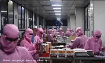  ?? Workers pack syringes at a factory in Faridabad ??
