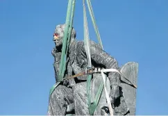  ??  ?? GOING, GOING, GONE: Students cheer as the statue of Cecil John Rhodes is removed from the campus of the University of Cape Town after weeks of protest and a decision by UCT authoritie­s and heritage officials to get rid of it