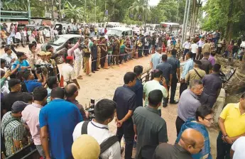  ?? AP ?? A crowd gathers at the site of an explosion near a busy market in Guwahati, Assam’s capital, yesterday. The minor blast hit a busy shopping district in the northeaste­rn Indian state, outside the office of a district magistrate.