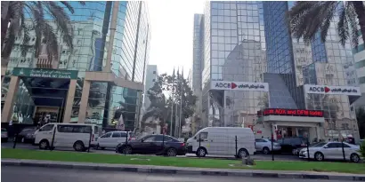  ??  ?? Vehicles pass financial institutio­ns on Bank Street in Dubai. The end of the commoditie­s boom has also increased the pressure on GCC banks’ asset quality and profitabil­ity indicators. — Photo by Dhes Handumon