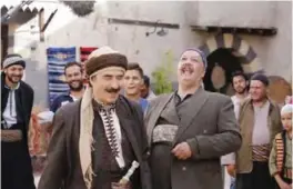  ??  ?? Syrian artist Rashid Assaf (center left) is seen on the filming set of television series ‘Tawq Al-Banat’ in the village of Yaafur.