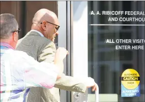  ?? Christian Abraham / Hearst Connecticu­t Media ?? Former Monsignor Kevin Wallin and a friend, left, enter the federal courthouse in Hartford on Thursday. The disgraced former Bridgeport Diocese priest, whose addiction and drug dealing earned him the nickname “Monsignor Meth,” was sent to federal prison for violating parole after testing positive for methamphet­amine