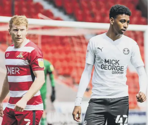  ??  ?? Adler Nascimento (right) on his Football League debut for Posh at Doncaster last season. Photo: Joe Dent/theposh.com.