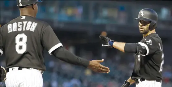  ?? NAM Y. HUH/AP ?? Ryan LaMarre, who started in left field Friday, celebrates with first-base coach Daryl Boston after hitting an RBI single in the third inning against the Royals.