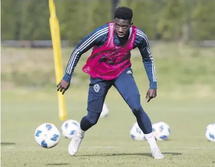  ?? DARRYL DYCK/THE CANADIAN PRESS ?? Whitecaps midfielder Alphonso Davies controls the ball during practice in Vancouver on Wednesday. The Edmonton teen will play for Germany’s Bayern Munich next year.