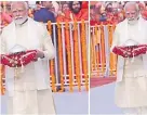  ?? Picture: THE HINDUSTAN TIMES ?? Dressed in a golden kurta teamed up with a cream dhoti and patka, India’s PM Modi walked into the sanctum sanctorum of the temple holding a silver umbrella on a folded red dupatta.
