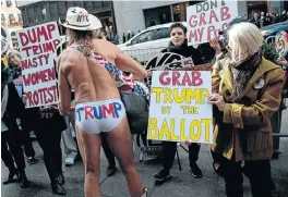  ?? Picture: GETTY IMAGES ?? BUM IDEA: Robert Burck, famous to tourists as the ’Naked Cowboy’ of Times Square, confronts anti-Trump protesters during a ’Nasty Women’ rally outside Trump Tower in New York